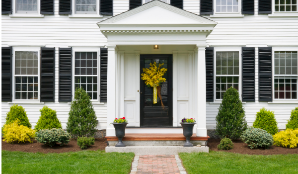 image of a stately home with a lovely landscape